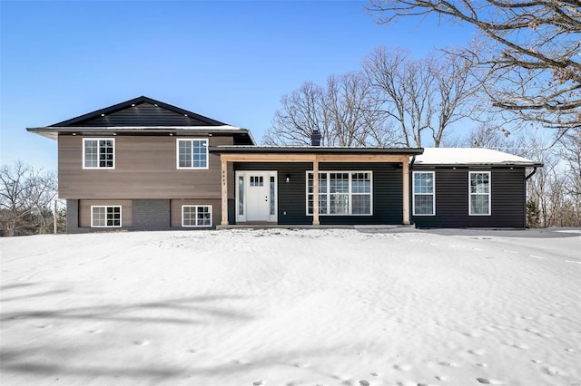 tri-level home featuring brick siding