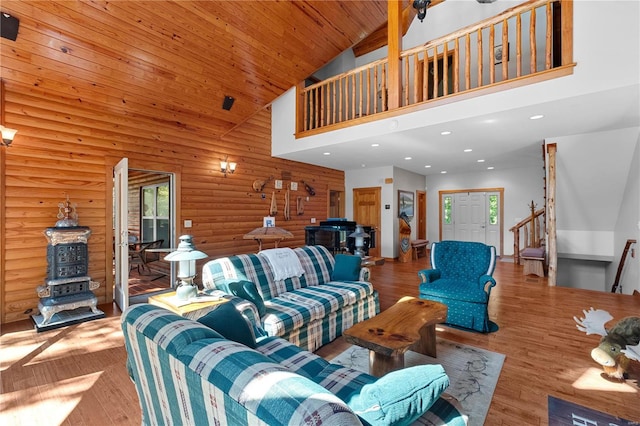 living room featuring light wood-type flooring, high vaulted ceiling, wooden ceiling, and rustic walls