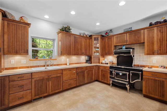 kitchen featuring extractor fan, sink, and tasteful backsplash