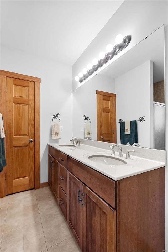 bathroom featuring walk in shower, vanity, and tile patterned flooring