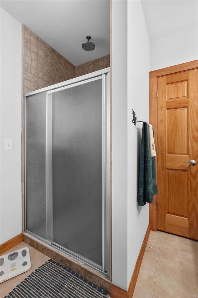 bathroom with tile patterned flooring and walk in shower