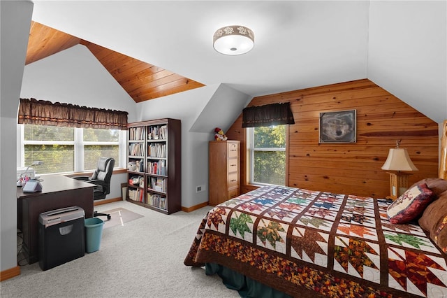 bedroom featuring wood walls, light colored carpet, vaulted ceiling, and multiple windows