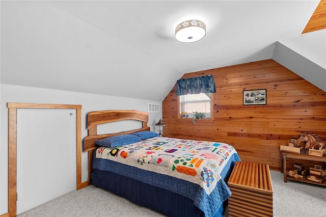 carpeted bedroom featuring wood walls and vaulted ceiling