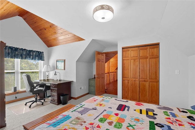 bedroom featuring a closet, wooden ceiling, vaulted ceiling, and light carpet