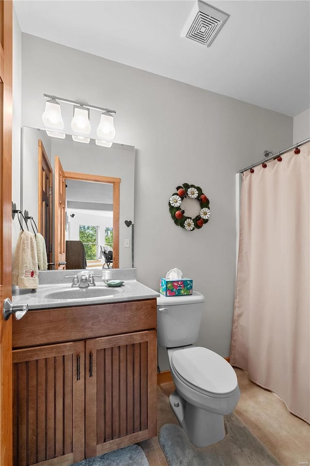 bathroom with walk in shower, vanity, toilet, and tile patterned floors