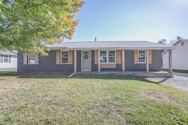 ranch-style home with covered porch and a front yard