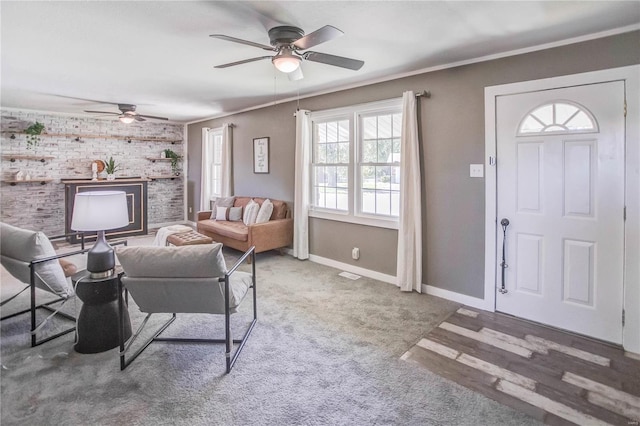 living room featuring carpet floors, ornamental molding, and a healthy amount of sunlight