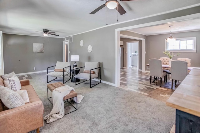 living room with light wood-type flooring and ceiling fan