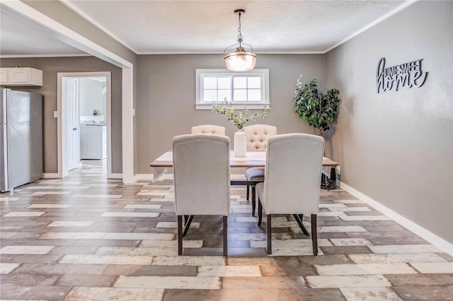 dining area featuring crown molding and washer / dryer