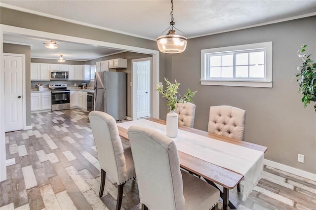 dining area with light hardwood / wood-style floors and sink