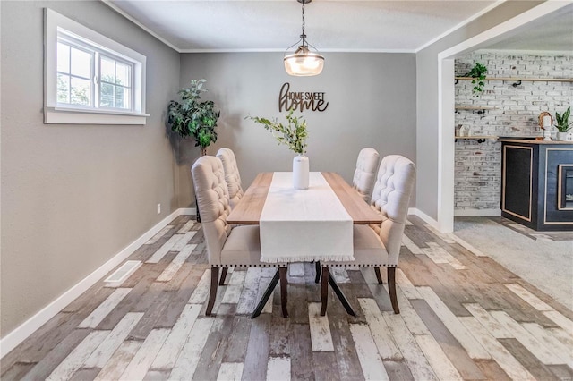 dining area featuring crown molding and wood-type flooring