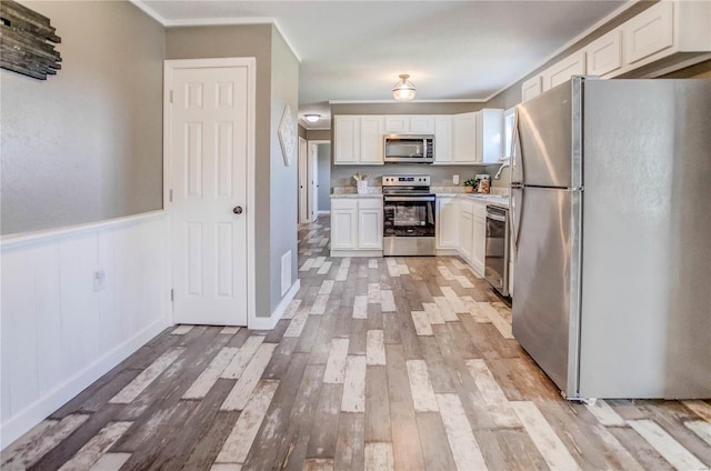 kitchen featuring white cabinetry, stainless steel appliances, and light hardwood / wood-style flooring