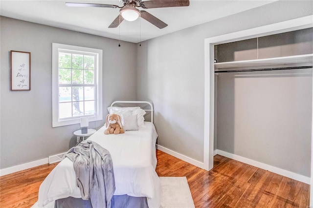 bedroom featuring ceiling fan, a closet, and hardwood / wood-style floors