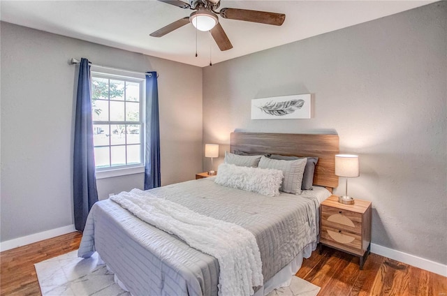 bedroom featuring ceiling fan and dark wood-type flooring