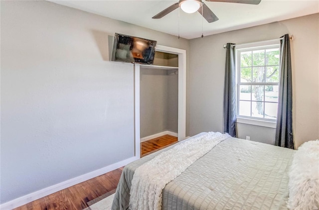 bedroom with ceiling fan, hardwood / wood-style flooring, and a closet