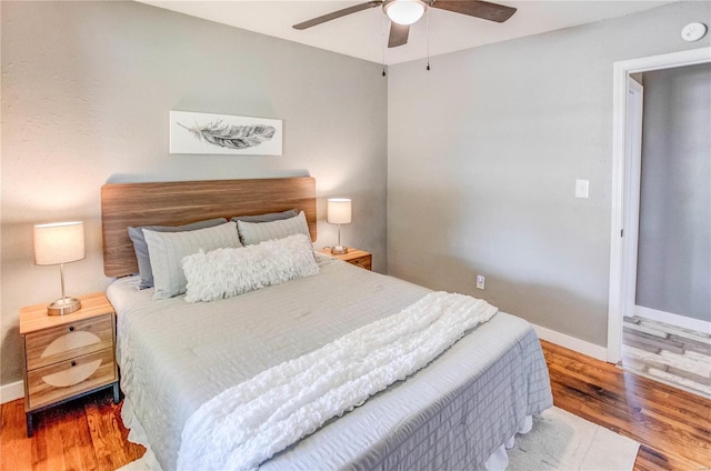 bedroom with hardwood / wood-style flooring and ceiling fan