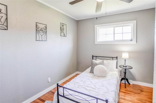 bedroom with hardwood / wood-style floors and ceiling fan