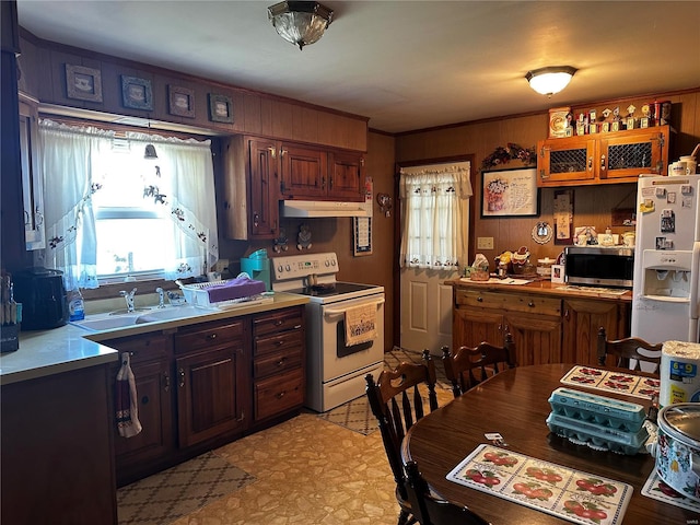 kitchen featuring a sink, white appliances, light floors, light countertops, and under cabinet range hood