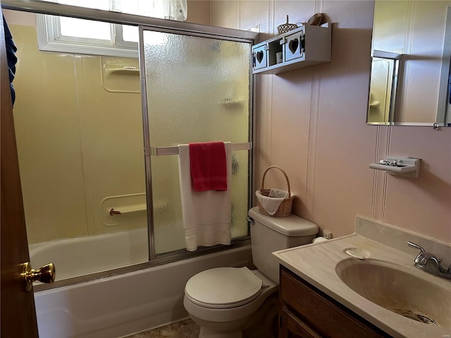full bathroom featuring bath / shower combo with glass door, toilet, and vanity