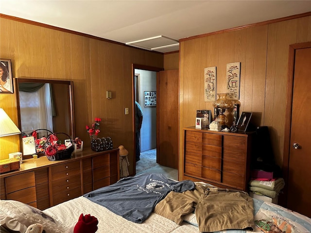 bedroom featuring attic access, wood walls, and carpet flooring