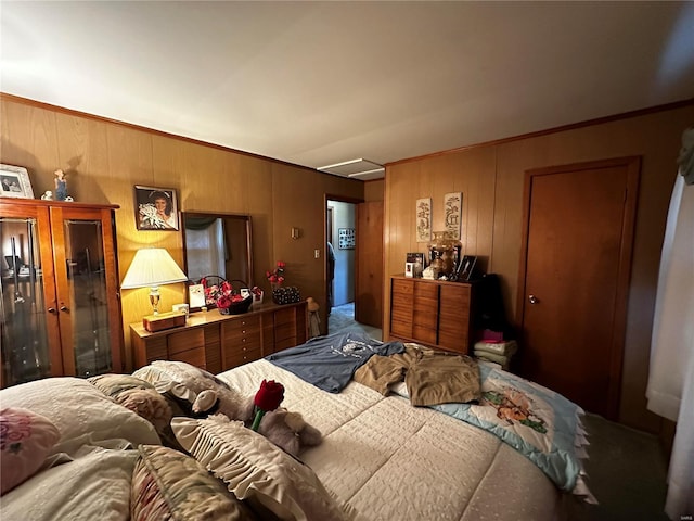 carpeted bedroom featuring wooden walls and crown molding