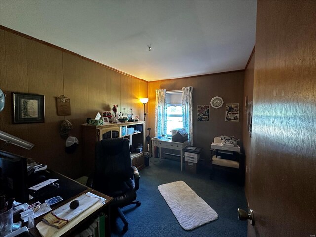 home office with carpet and wood walls
