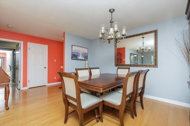 dining area featuring a chandelier and light wood-type flooring