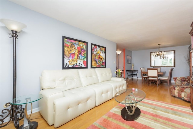 living room featuring a chandelier and wood-type flooring