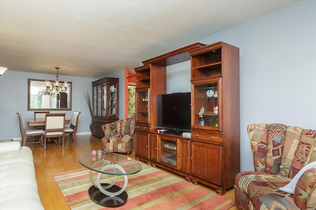 living room with an inviting chandelier and light hardwood / wood-style flooring