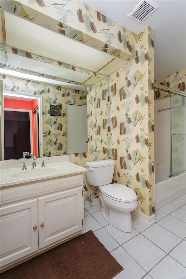 full bathroom featuring toilet, tile patterned flooring, vanity, and enclosed tub / shower combo