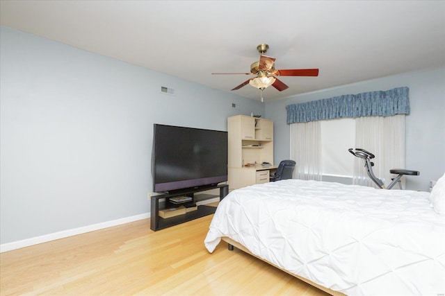 bedroom with light wood-type flooring and ceiling fan