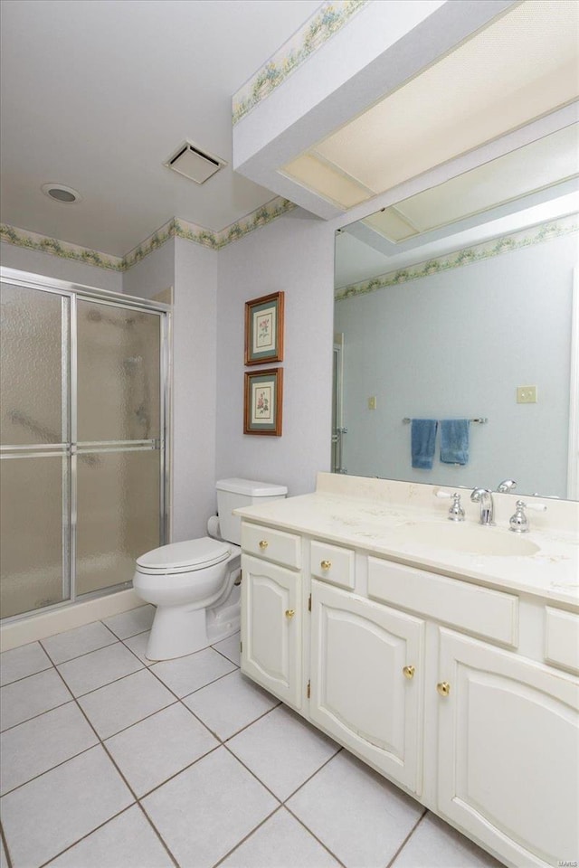 bathroom with tile patterned floors, an enclosed shower, toilet, and vanity