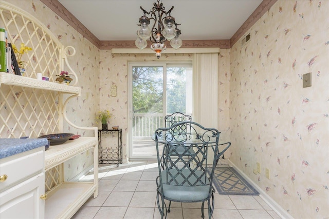 tiled dining space featuring an inviting chandelier