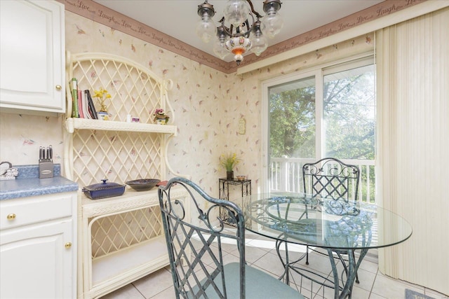 dining space featuring an inviting chandelier and light tile patterned floors