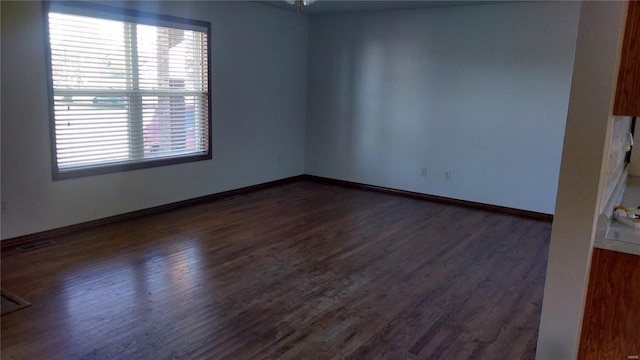 unfurnished room featuring dark hardwood / wood-style floors