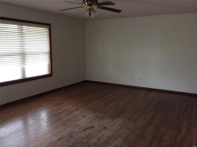 spare room featuring ceiling fan and dark hardwood / wood-style flooring