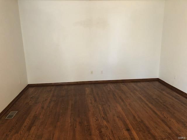 empty room with dark hardwood / wood-style floors