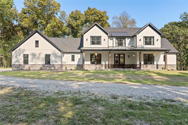 modern inspired farmhouse with covered porch and a front yard