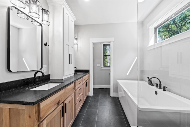 bathroom featuring vanity, a bathing tub, and tile patterned floors