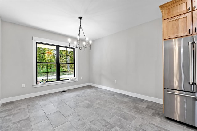 unfurnished dining area with a chandelier