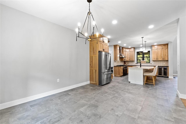 kitchen featuring a breakfast bar area, decorative light fixtures, sink, appliances with stainless steel finishes, and a center island