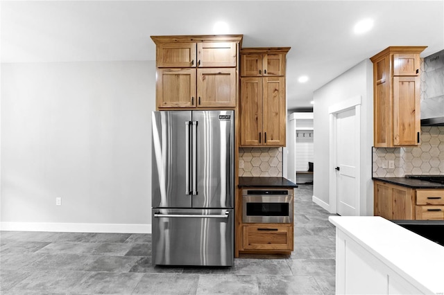 kitchen with stainless steel appliances and tasteful backsplash