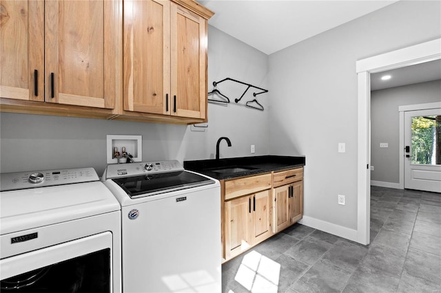 laundry area with cabinets, tile patterned flooring, sink, and washing machine and dryer