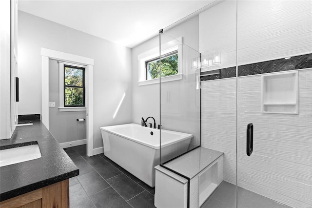 bathroom featuring tile patterned floors, vanity, and independent shower and bath