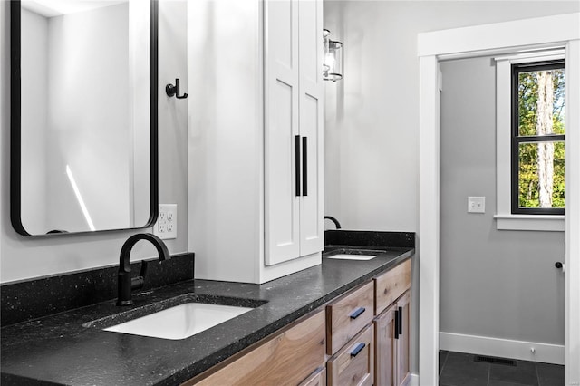 bathroom with tile patterned flooring and vanity