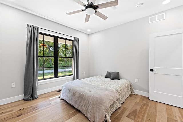 bedroom with ceiling fan and wood-type flooring