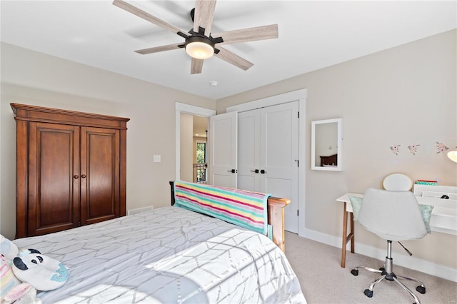 carpeted bedroom with a closet and ceiling fan