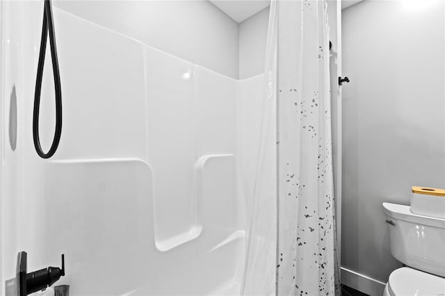 bathroom with shower / tub combo and toilet