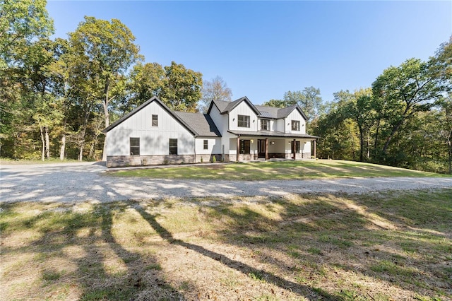 modern farmhouse style home featuring a front lawn and covered porch