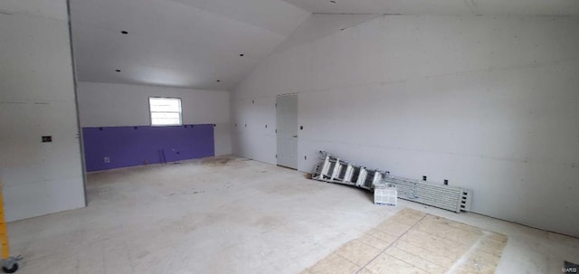 unfurnished room featuring high vaulted ceiling